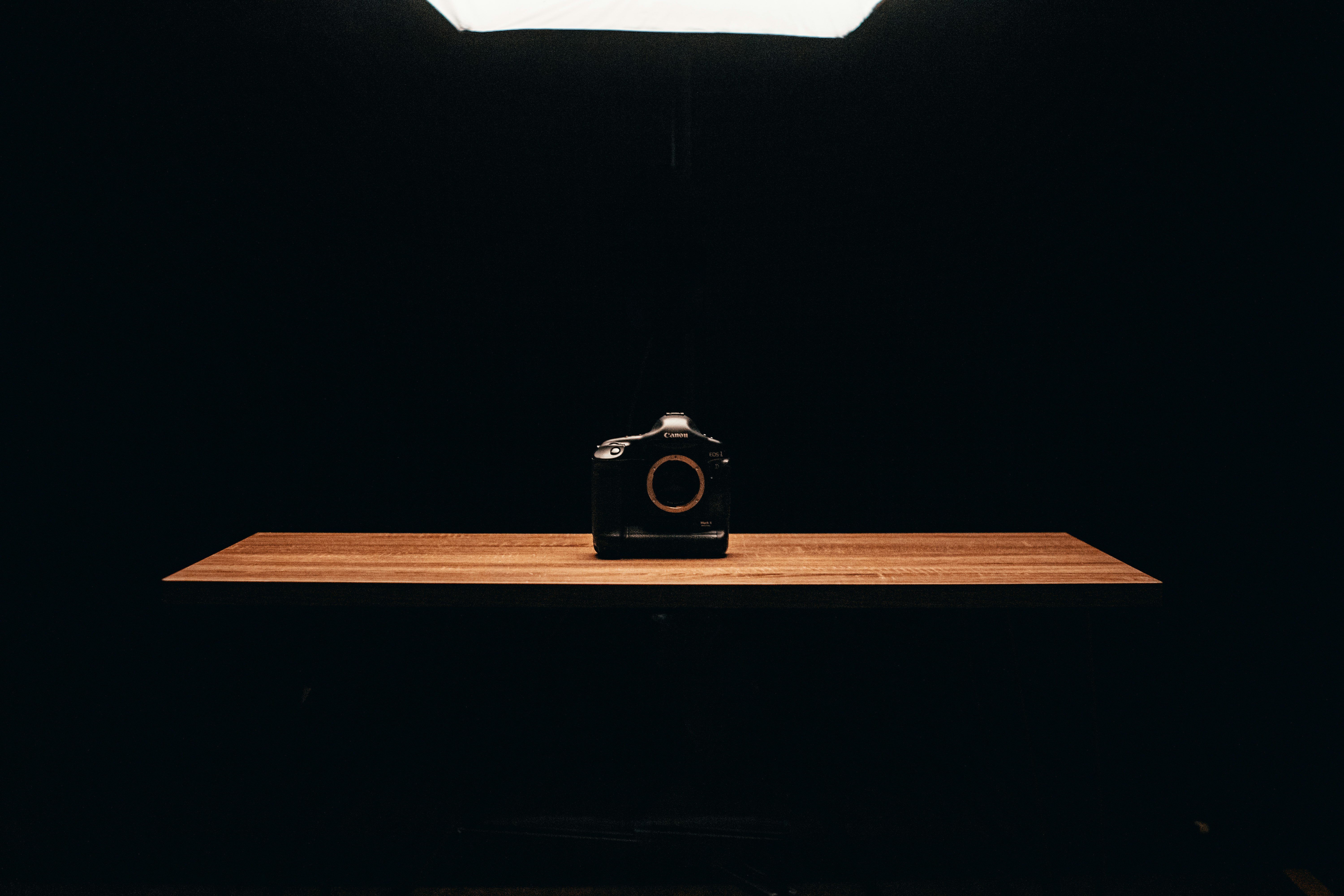 black point and shoot camera on brown wooden table